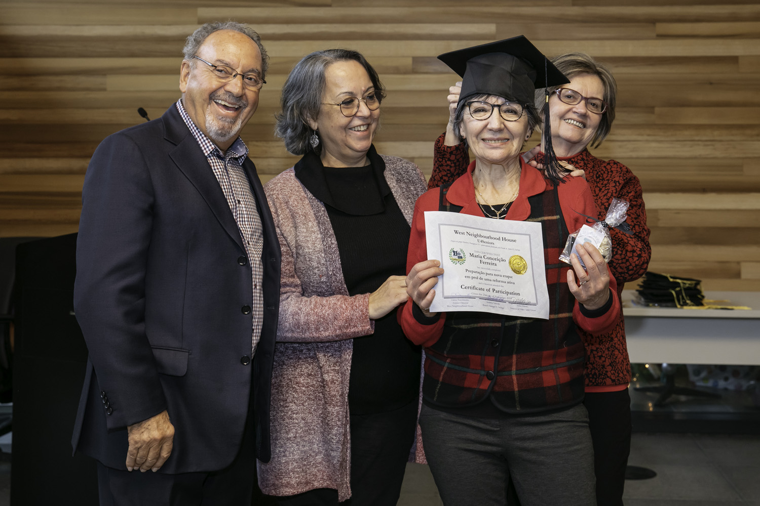 A beaming student graduates from the financial literacy program, supported by MGI Financial Inc.