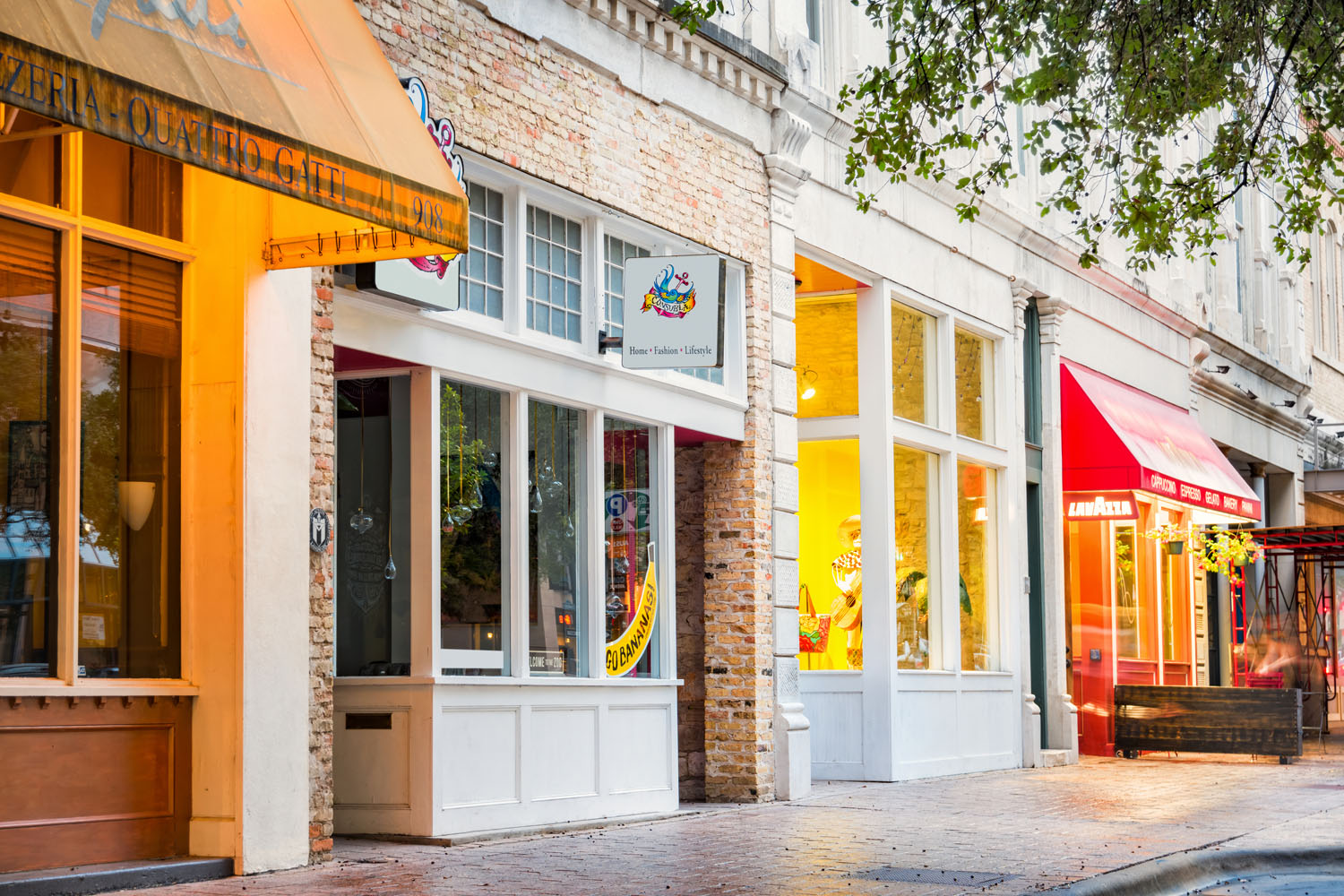 Colourful shops and restaurants line the city street.