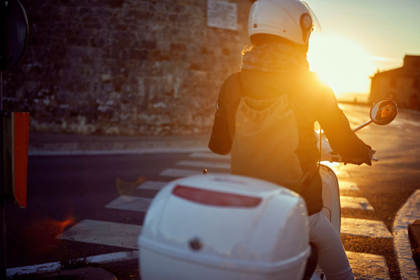 Heading out on an early morning adventure on a Vespa.