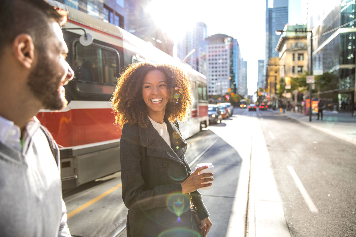 Young friends cross busy street in downtown Ontario.